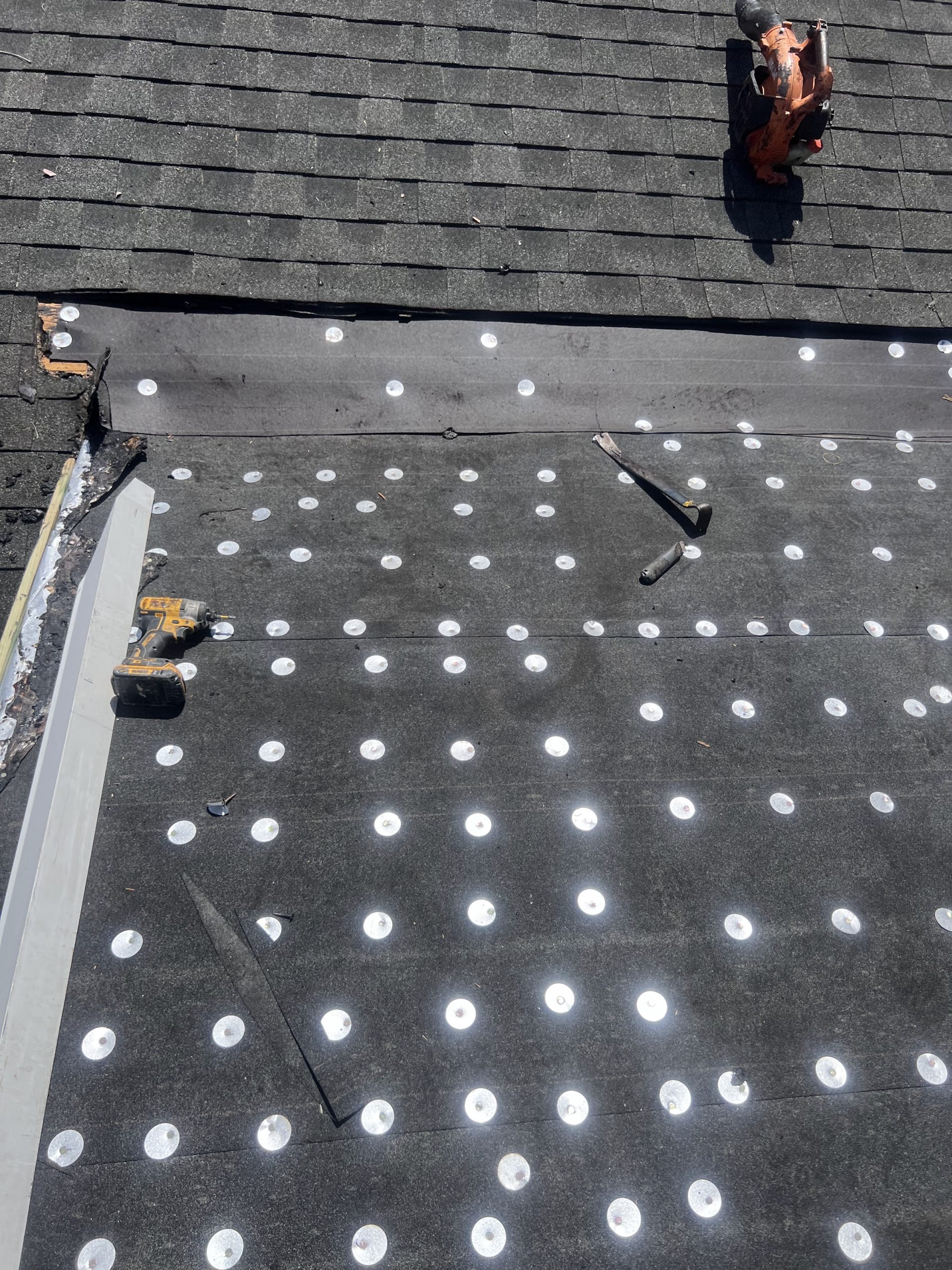 Nailed underlayment on a roof replacement