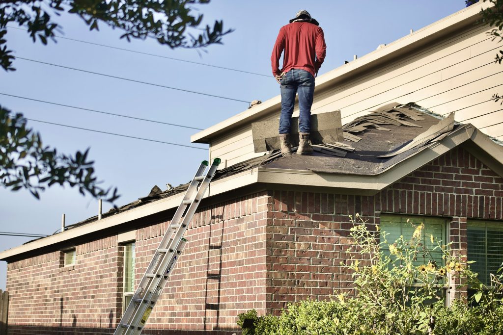 Roofer working on a roof tear-off before a roof replacement